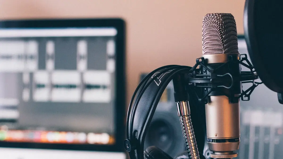 A Røde NT1A microphone, AKG K171 headphones, desk stand with pop shield and iMac running Reaper.